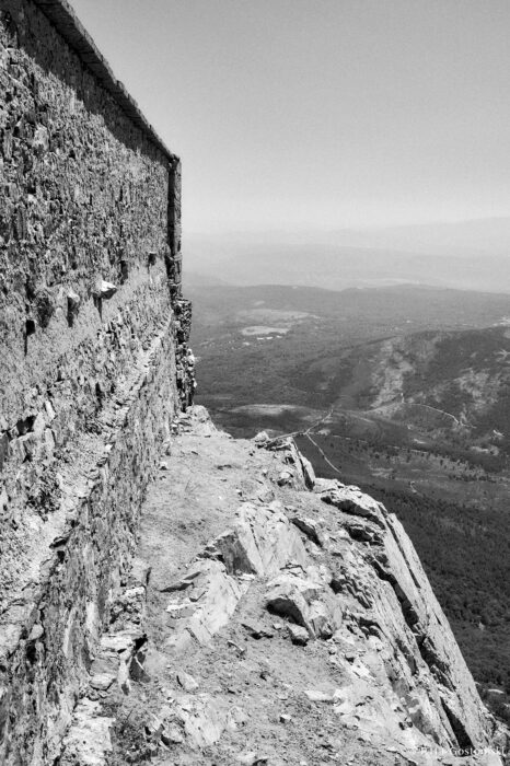 Views of the Sierra de Francia A black and white photo looking along a stone wall with Views of the Sierra de Francia